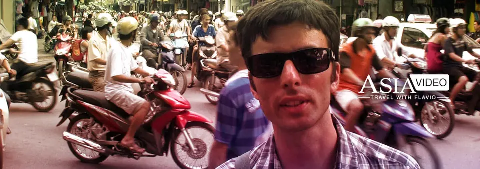 A street in Hanoi’s old quarter with motorbikes and shop signs